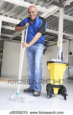 Stock Photography - Cleaner mopping office floor. Fotosearch
