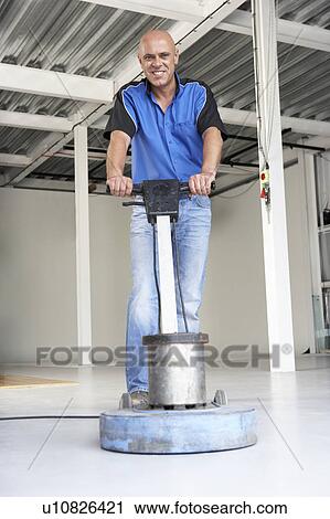 Stock Image - Cleaner polishing office floor. Fotosearch