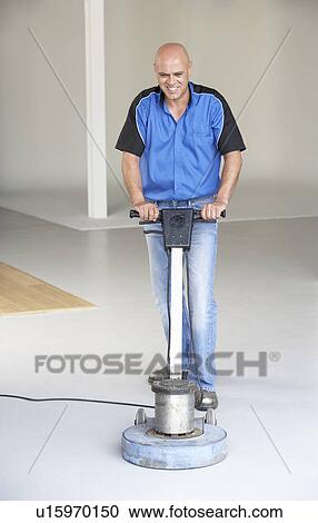 Cleaner polishing office floor View Large Photo Image Stock Image - Cleaner polishing office floor. Fotosearch