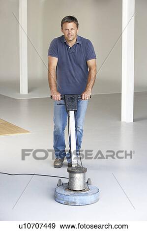Stock Photo - Cleaner polishing office floor. Fotosearch