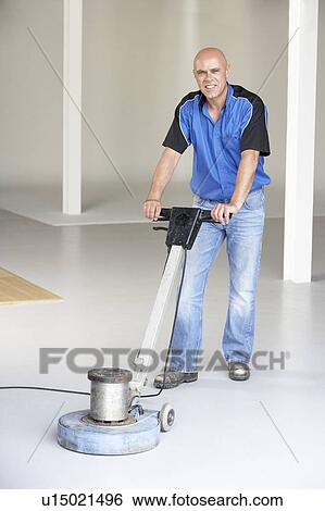 Cleaner polishing office floor View Large Photo Image Stock Photograph - Cleaner polishing office floor. Fotosearch