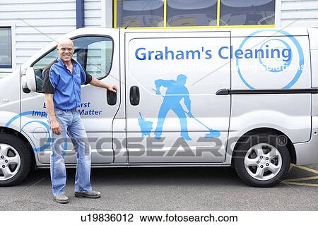 Stock Image - Cleaner standing next to van. Fotosearch