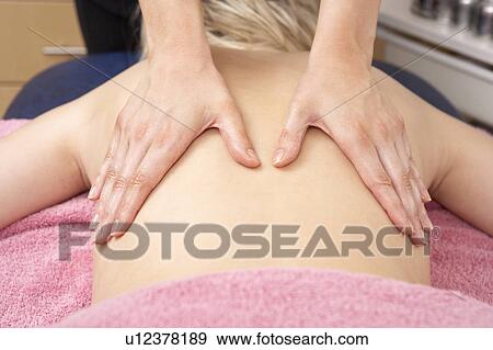 Stock Photo - Close Up of female masseuse with client. Fotosearch