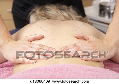 Stock Photo - Close Up of female masseuse with client. Fotosearch