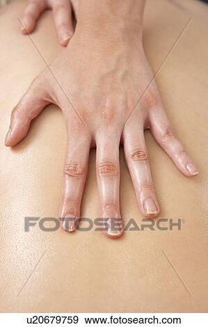 Stock Photo - Close Up of female masseuse with client. Fotosearch