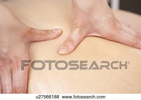 Stock Photo - Close Up of female masseuse with client. Fotosearch