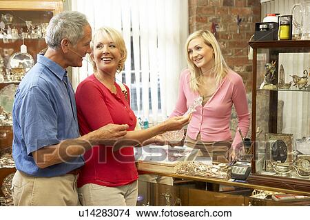 Couple shopping in antique shop View Large Photo Image Picture - Couple shopping in antique shop. Fotosearch