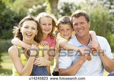 Stock Image - Family having fun in countryside. Fotosearch
