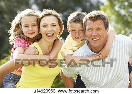 Stock Image - Family having fun in countryside. Fotosearch