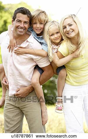 Stock Image - Family having fun in countryside. Fotosearch
