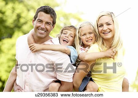 Stock Image - Family having fun in countryside. Fotosearch