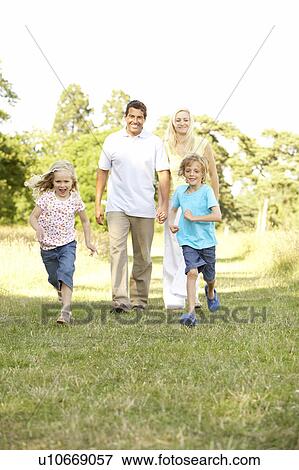 Stock Photo - Family having fun in countryside. Fotosearch