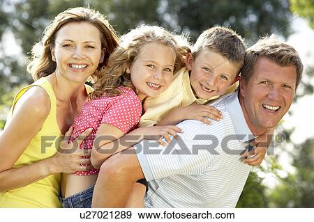 Stock Photo - Family having fun in countryside. Fotosearch