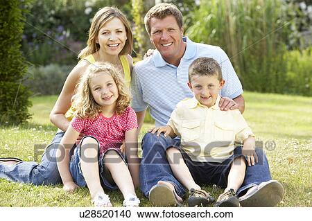 Stock Image - Family relaxing in countryside. Fotosearch