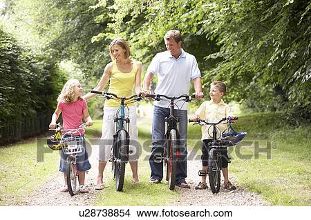 Picture - Family riding bikes in countryside. Fotosearch