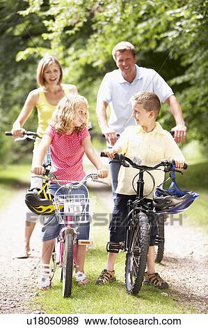 Family riding bikes in countryside View Large Photo Image Stock Photo - Family riding bikes in countryside. Fotosearch