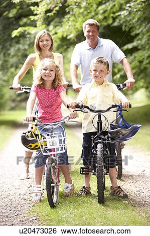 Family riding bikes in countryside View Large Photo Image Stock Photograph - Family riding bikes in countryside. Fotosearch