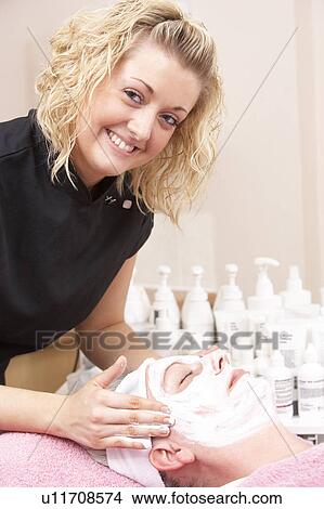 Female masseuse giving client facial View Large Photo Image Picture - Female masseuse giving client facial. Fotosearch