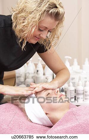 Female masseuse giving client facial View Large Photo Image Stock Photography - Female masseuse giving client facial. Fotosearch