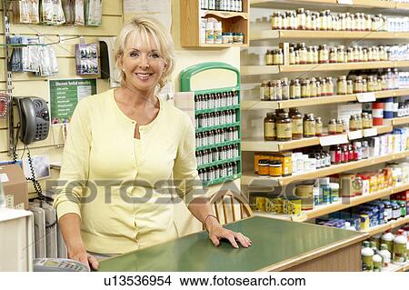 Female sales assistant in health food store View Large Photo Image Picture - Female sales assistant in health food store. Fotosearch
