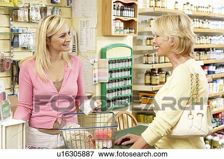 Female sales assistant in health food store View Large Photo Image Stock Photo - Female sales assistant in health food store. Fotosearch