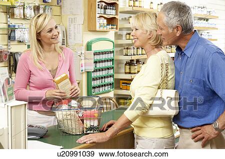 Female sales assistant in health food store View Large Photo Image Stock Photo - Female sales assistant in health food store. Fotosearch