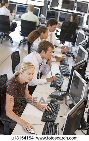 Picture - High Angle View Of Stock Traders At Work. Fotosearch