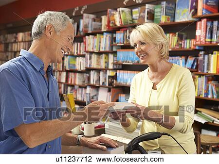 Male customer in bookshop View Large Photo Image Stock Image - Male customer in bookshop. Fotosearch