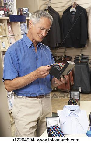 Picture - Male customer in clothing store. Fotosearch
