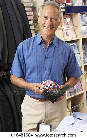 Male customer in clothing store View Large Photo Image Picture - Male customer in clothing store. Fotosearch