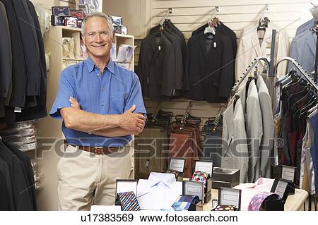 Male sales assistant in clothing store View Large Photo Image Stock Photo - Male sales assistant in clothing store. Fotosearch