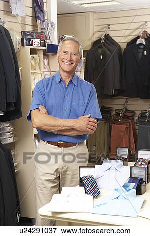 Male sales assistant in clothing store View Large Photo Image Stock Photo - Male sales assistant in clothing store. Fotosearch