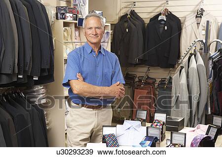 Male sales assistant in clothing store View Large Photo Image Stock Photo - Male sales assistant in clothing store. Fotosearch