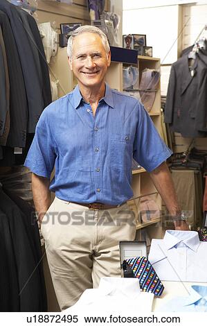 Male sales assistant in clothing store View Large Photo Image Stock Photography - Male sales assistant in clothing store. Fotosearch