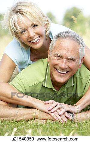 Mature couple having fun in countryside View Large Photo Image Stock Image - Mature couple having fun in countryside. Fotosearch