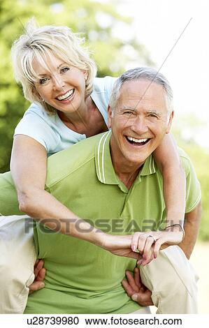 Mature couple having fun in countryside View Large Photo Image Stock Image - Mature couple having fun in countryside. Fotosearch