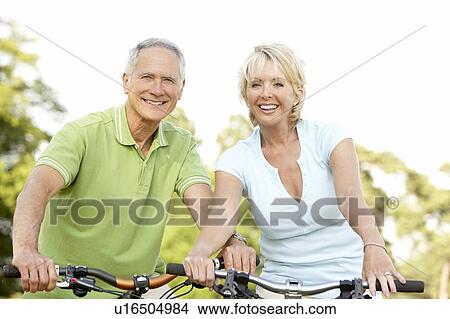 Picture - Mature couple riding bikes. Fotosearch