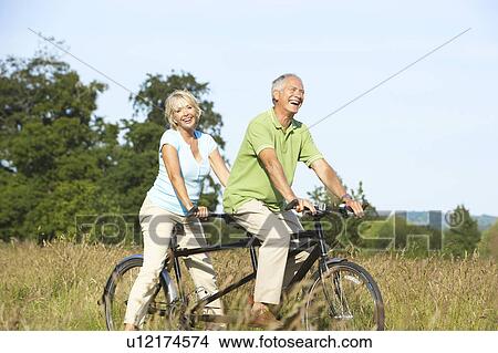 Mature couple riding tandem View Large Photo Image Picture - Mature couple riding tandem. Fotosearch