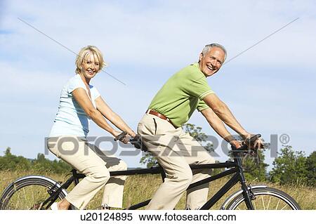 Mature couple riding tandem View Large Photo Image Stock Photography - Mature couple riding tandem. Fotosearch