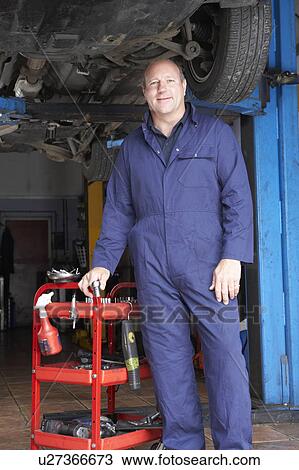 Mechanic working on car View Large Photo Image Stock Image - Mechanic working on car. Fotosearch