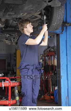 Stock Photo - Mechanic working on car. Fotosearch