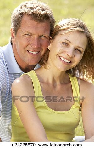 Stock Image - Middle aged couple having fun in countryside. Fotosearch