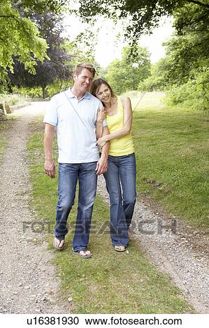 Stock Image - Middle aged couple walking in countryside. Fotosearch