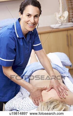 Osteopath treating female client View Large Photo Image Stock Photo - Osteopath treating female client. Fotosearch