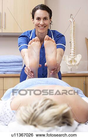 Osteopath treating female client View Large Photo Image Stock Photograph - Osteopath treating female client. Fotosearch