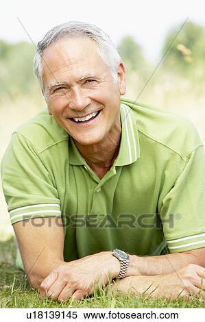 Stock Photography - Portrait of mature man relaxing in countryside. Fotosearch