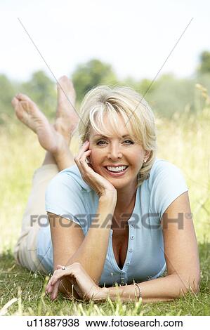 Portrait of mature woman relaxing in countryside View Large Photo Image Stock Photo - Portrait of mature woman relaxing in countryside. Fotosearch