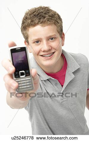 Portrait of Smiling Teenage Boy Holding Mobile Phone View Large Photo Image Stock Photo - Portrait of Smiling Teenage Boy Holding Mobile Phone. Fotosearch