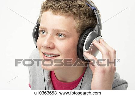 Portrait of Smiling Teenage Boy Listening to Music View Large Photo Image Stock Image - Portrait of Smiling Teenage Boy Listening to Music. Fotosearch
