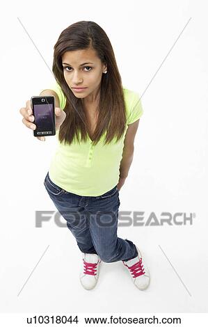 Portrait of Smiling Teenage Girl Holding Mobile Phone View Large Photo Image Picture - Portrait of Smiling Teenage Girl Holding Mobile Phone. Fotosearch